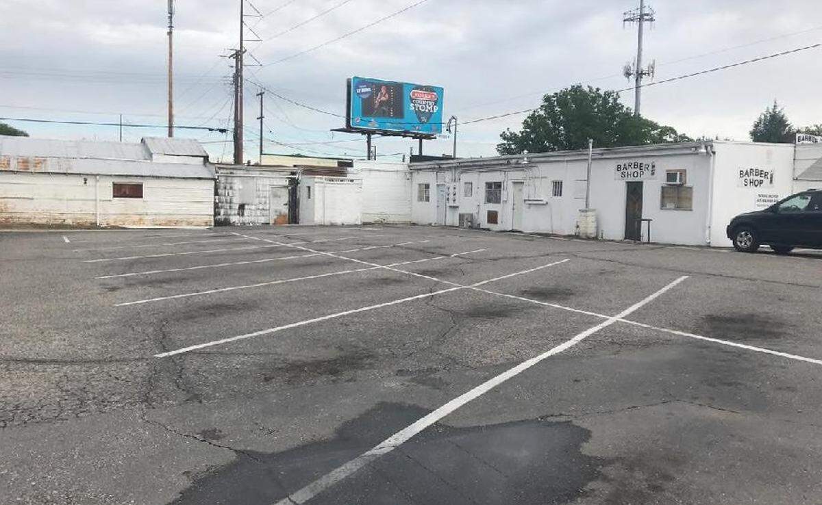 A deteriorated parking lot along West Overland Road, part of a proposed Bench urban renewal district.