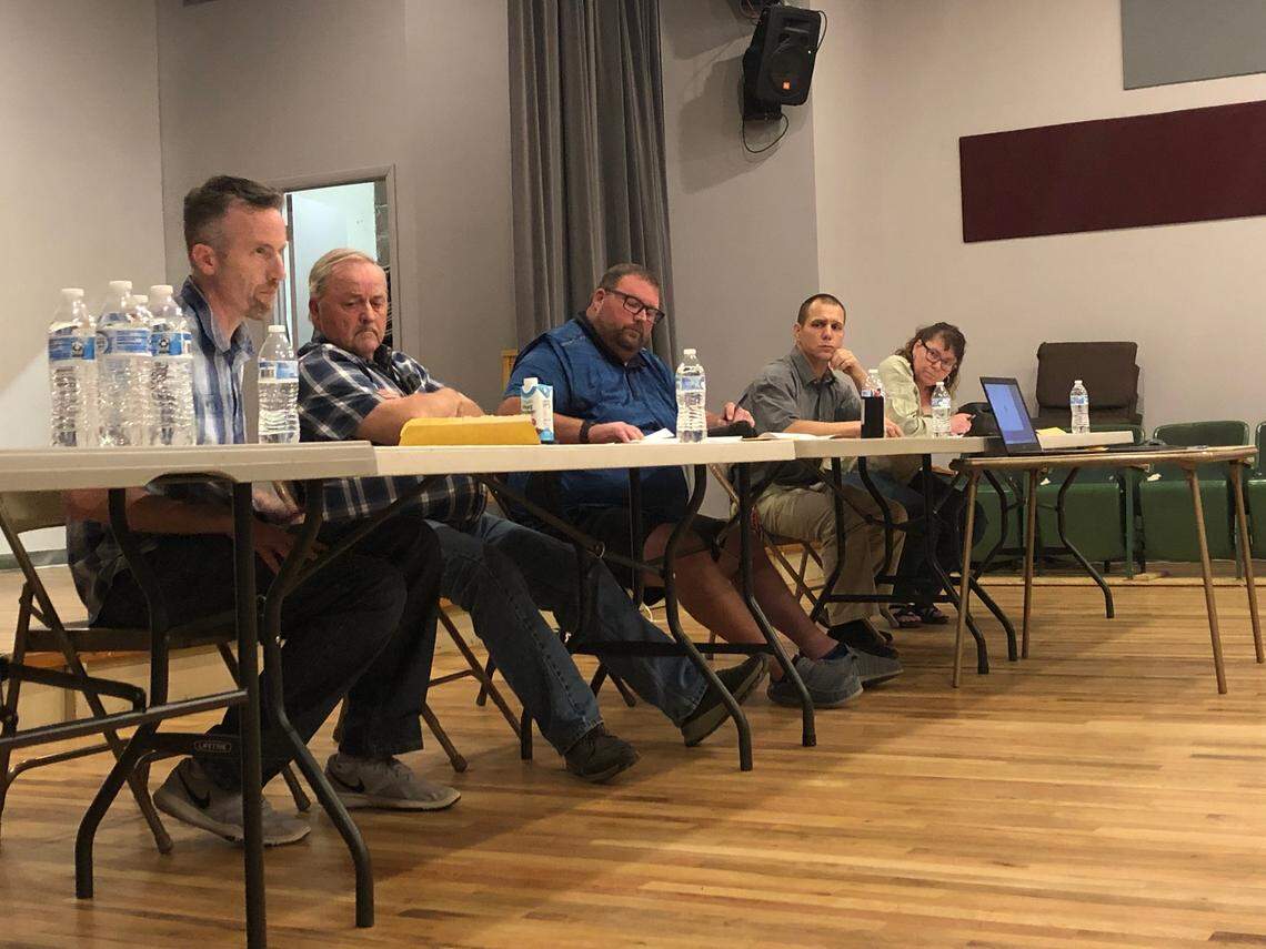From left, Melba City Council members Chris Hinderliter and Hal Forsgren, Mayor Cory Dickard, the council members Tyler Stapleton and Jeannine Johnshoy discuss enacting an emergency moratorium that would halt the processing of land divisions in Melba.