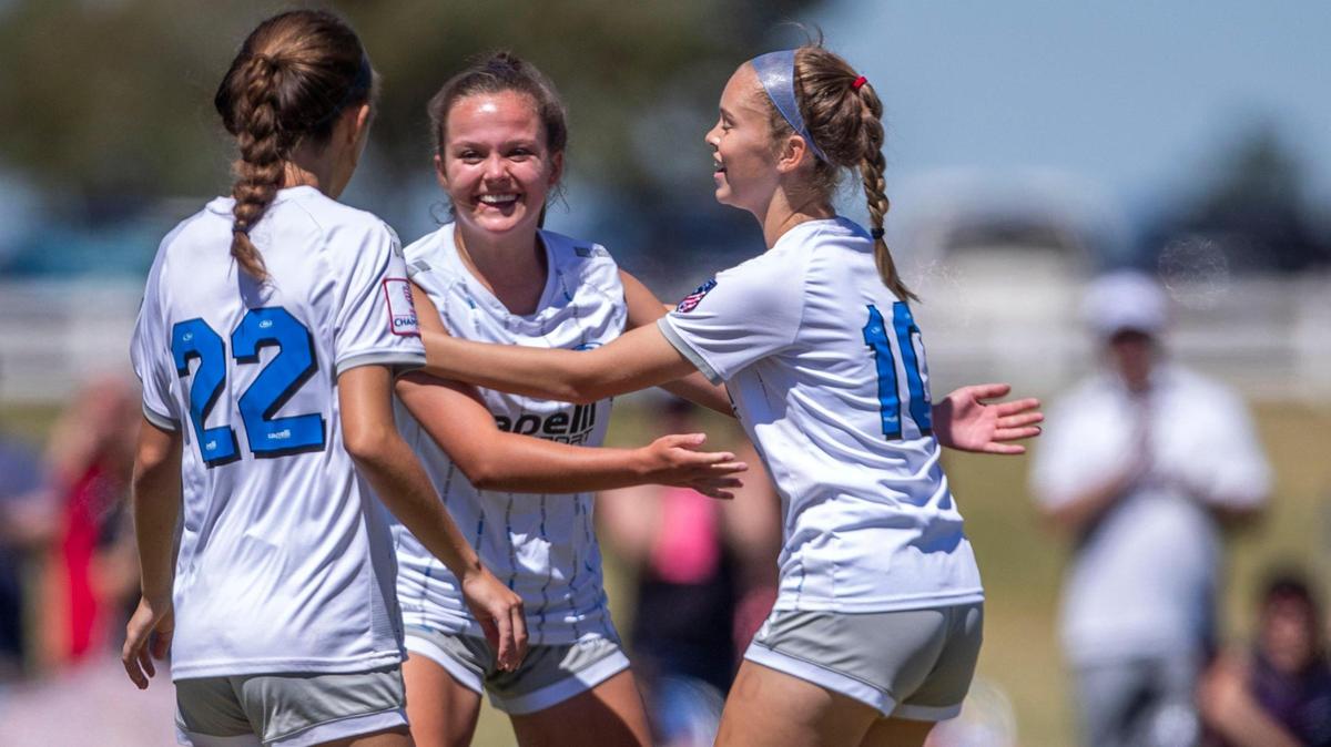 Idaho Rush teammates celebrate with Taylor Deitzel, center, after she scored their second goal against United PDX (Portland) in the U-15 girls semifinals of the U.S. Youth Soccer Far West Regional Championships on Saturday at the Simplot Sports Complex in East Boise.