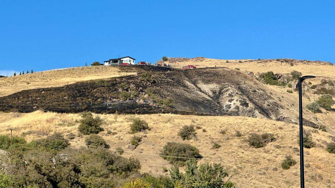 A fire in the Warm Springs Mesa area of Boise spread to about 10 acres shortly before 5 p.m. Wednesday. Fire crews protected two houses that were initially threatened.