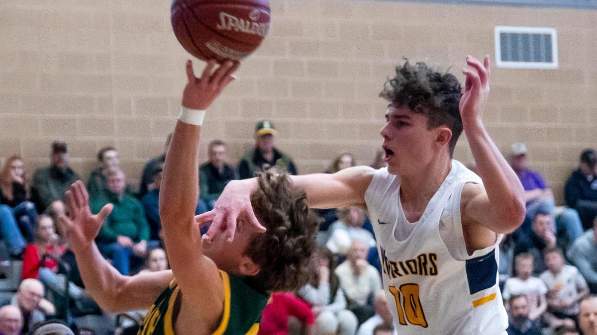 Meridian High guard Drayson Fisher misses the ball and blocks the face of Borah’s Luke Hoetker during the 5A District Three semifinals Saturday at Rocky Mountain.