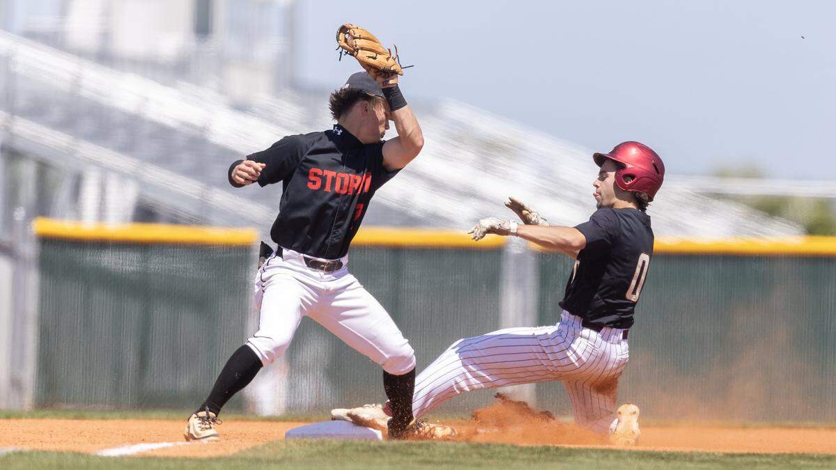 Rigby's Bentley Brower is safe at second base before Owyhee's Matt Robertson makes the catch during the 6A baseball regional tournament championship game, Saturday, May 9, 2026, held at Owyhee. Owyhee won 6-1.