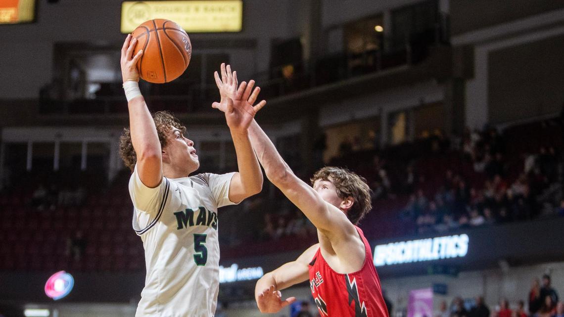 Mountain View senior Dyson Judd sinks a hook shot over an Owyhee defender Thursday.