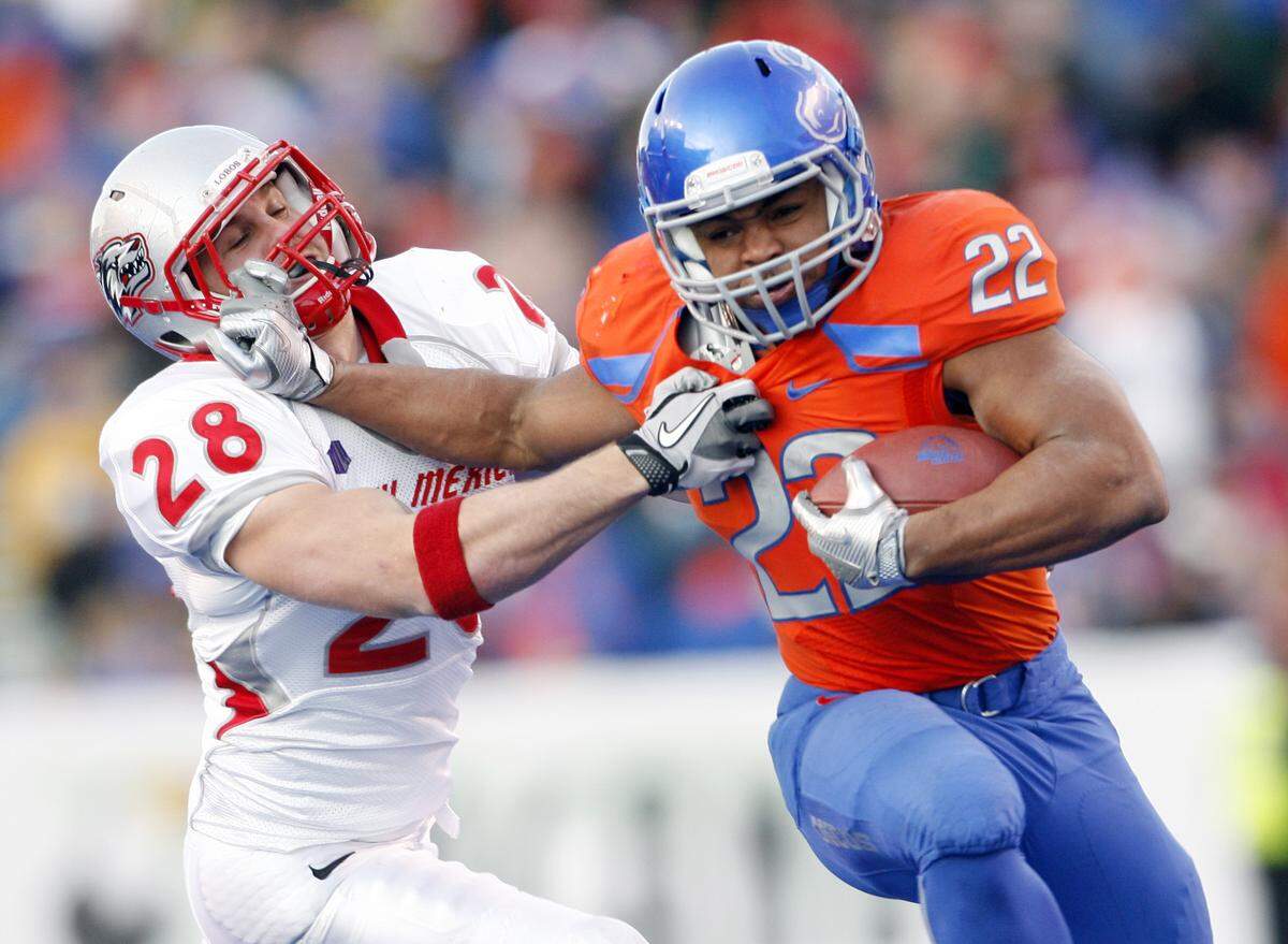 Doug Martin #22 of the Boise State Broncos fights off Bubba Forrest #28 of the New Mexico Lobos at Bronco Stadium on December 3rd, 2011