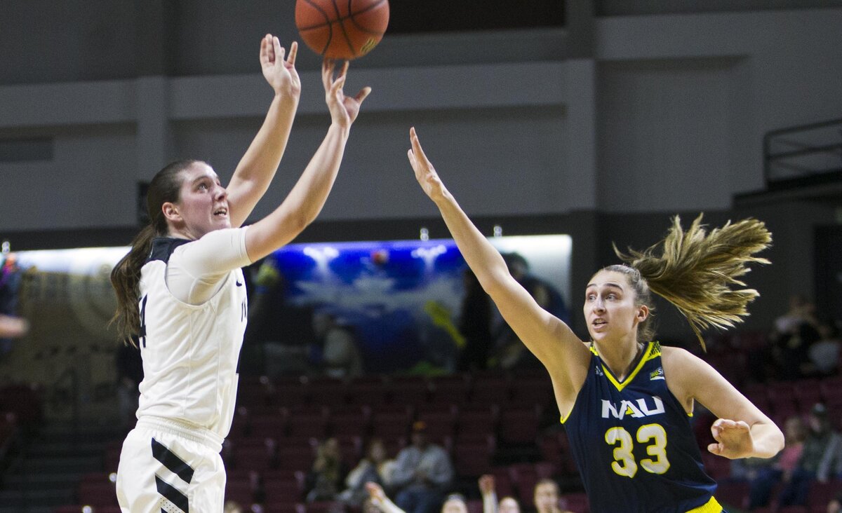 Idaho senior Taylor Pierce hits a 3-pointer while defended by Northern Arizona’s Peyton Carroll in the quarterfinals of the Big Sky Conference tournament last month at CenturyLink Arena in Downtown Boise.