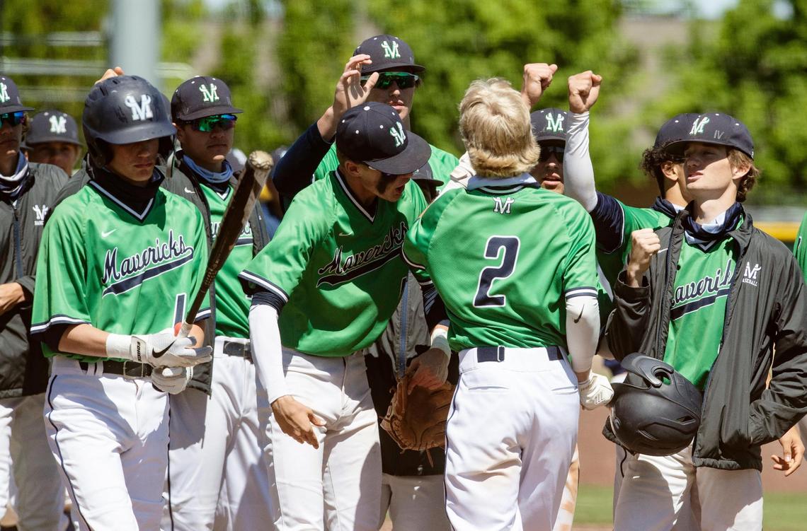 Mountian View surrounds Brooks Rasmussen (2) after scoring the go-ahead run on a balk Saturday against Capital in the first round of the 5A District Three baseball tournament.