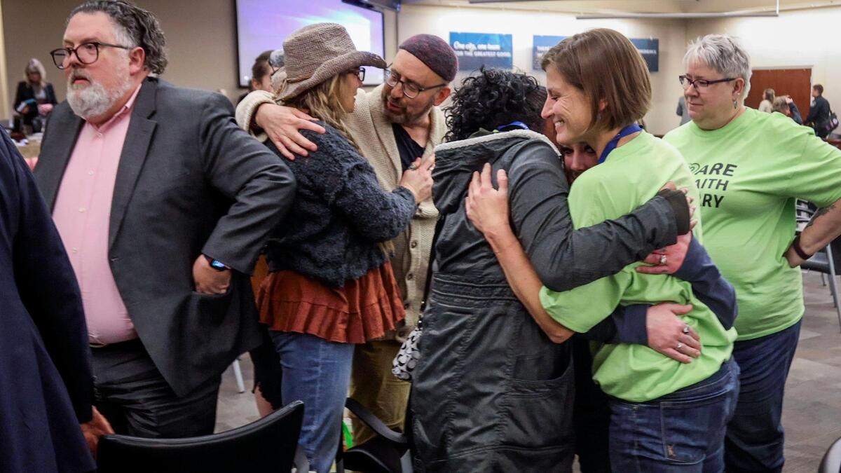 Members of the Interfaith Sanctuary team and supporters enjoy the moment after the Boise City Council voted to allow a new homeless shelter at 4306 W. State St. Executive Director Jodi Peterson-Stigers, center, said the decision was her birthday wish come true.