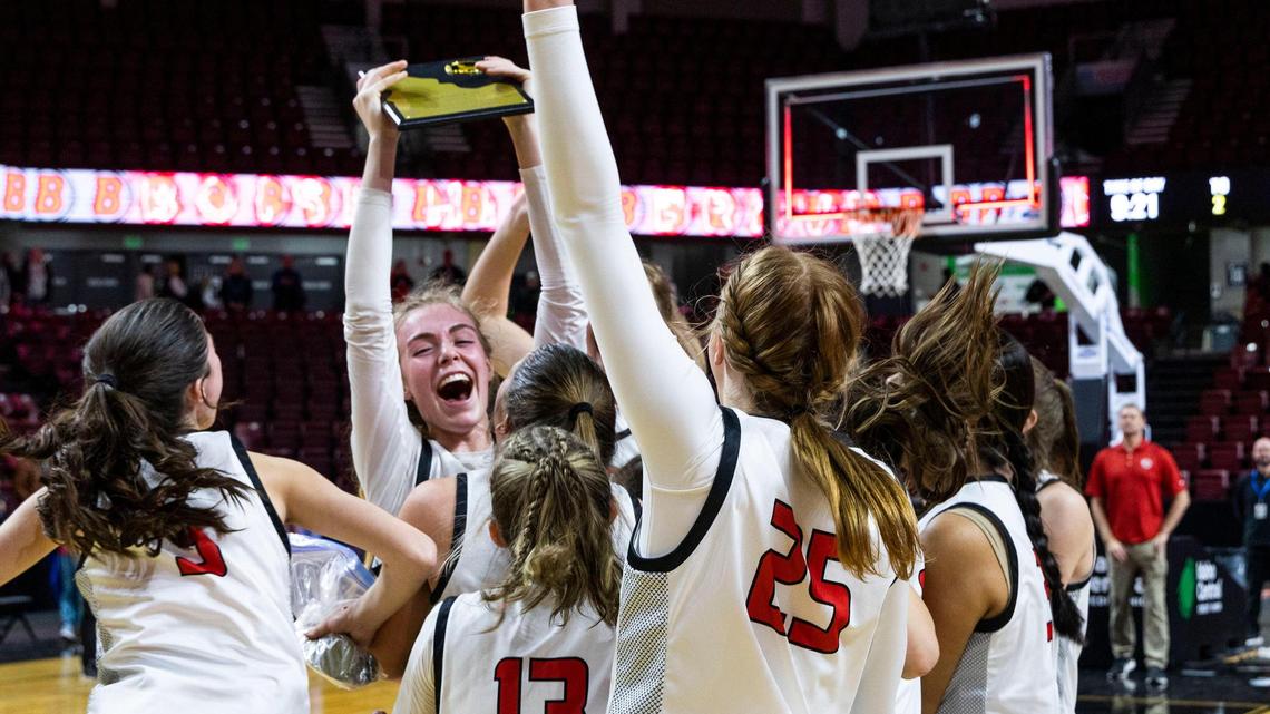 Boise junior Avery Howell holds up the 5A District Three girls basketball championship trophy after the Brave defeated Rocky Mountain 49-47 on Thursday at Idaho Central Arena in downtown Boise.