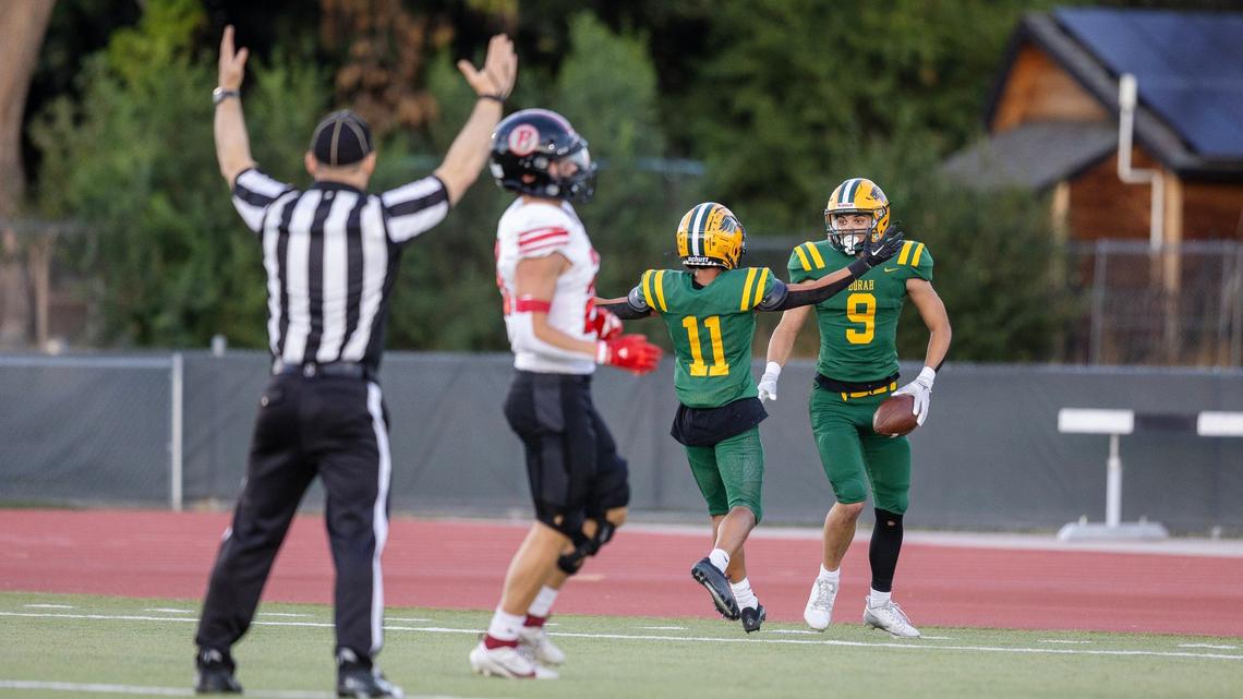 Borah wide receiver Mason Monteleone, right, celebrates a touchdown with teammate Ryan Lopez in the Lions’ 28-13 win over Boise on Thursday at Dona Larsen Park.