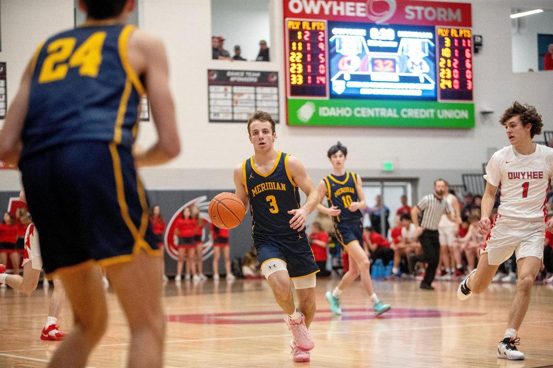 Meridian senior Josh Christensen dribbles the ball in the 5A District Three boys basketball tournament semifinals against Owyhee Tuesday, Feb. 21, 2023 at Owyhee High School.