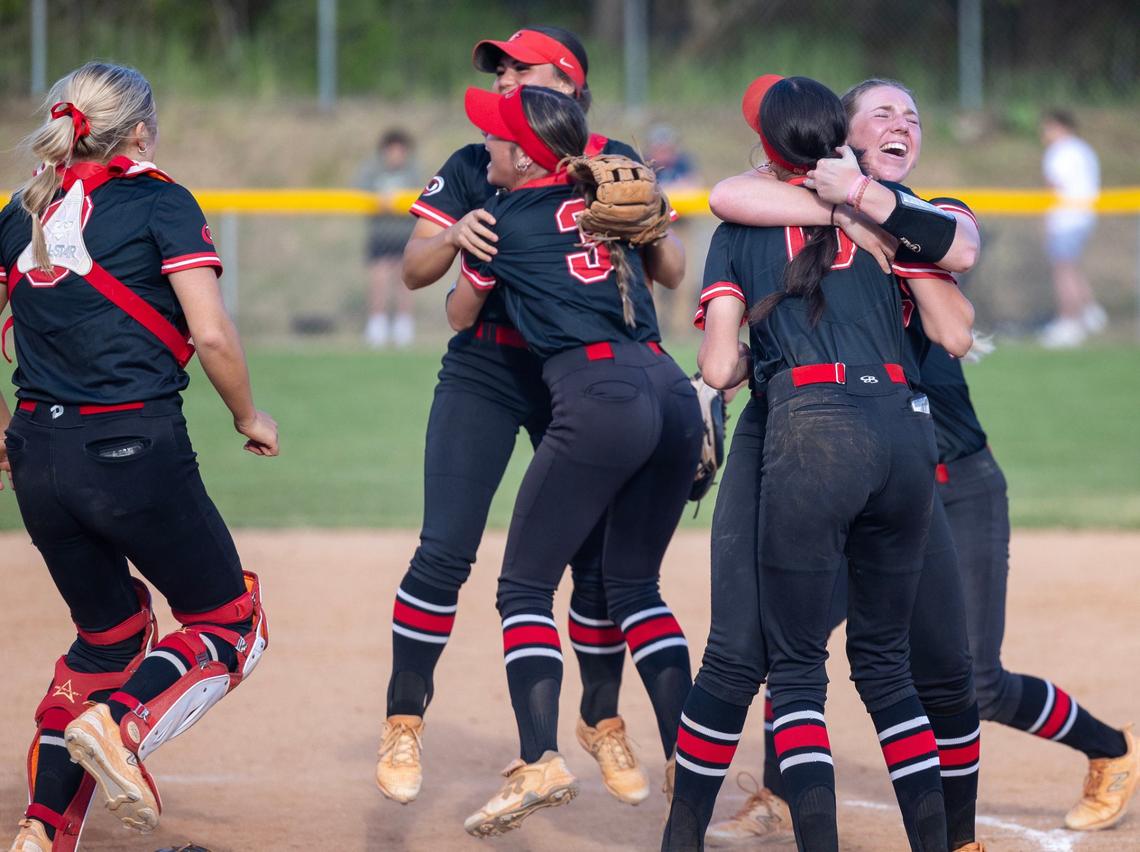 Owyhee softball players celebrate their win over Rocky Mountain in the 5A District Three Tournament championship Thursday at Mountain Cove Field.