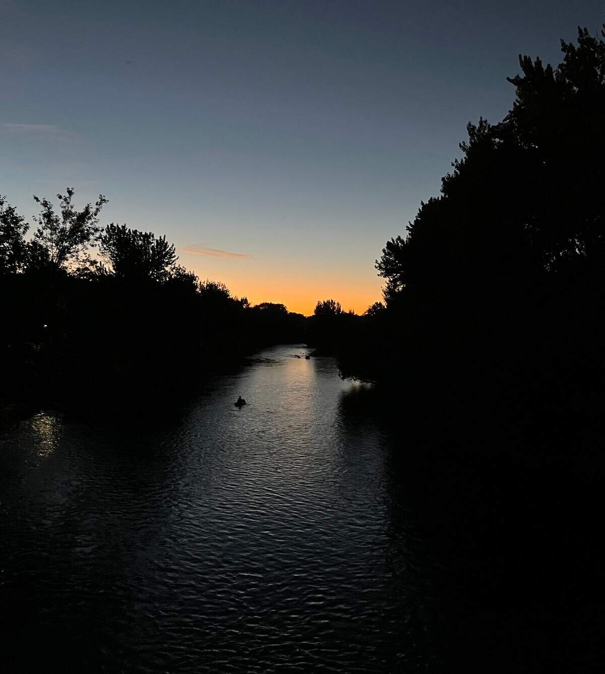 People raft down the Boise River in late September as the sun sets. 