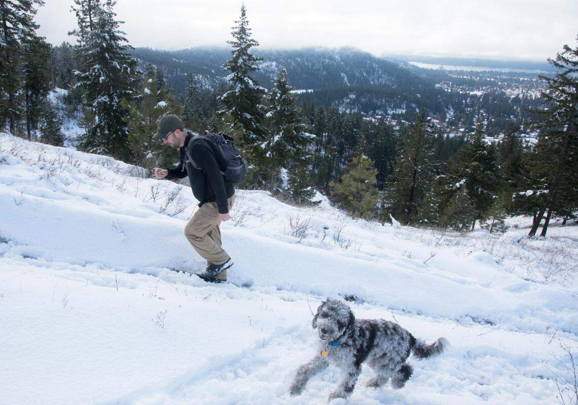 Jason Evans, left, hikes with his dog Cosmos on Thursday Jan. 24, 2019. 