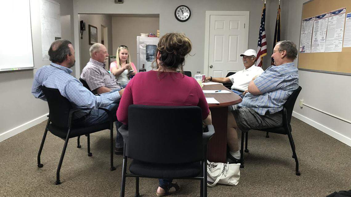 Members of the New Plymouth school board, as well as New Plymouth Superintendent Kevin Barker, far left, wait to go into closed-door session April 25, 2018, at a special meeting in the New Plymouth School district administrative office.