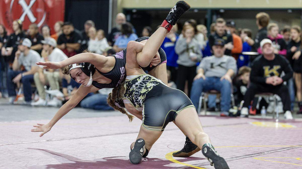 Idaho Fall's Airianna Ayala, top, and Kuna's Taylor Drake, bottom, wrestle at the Rollie Lane Invitational, Saturday, Jan. 3, 2026. Drake won the match 18-8 in a major decision.
