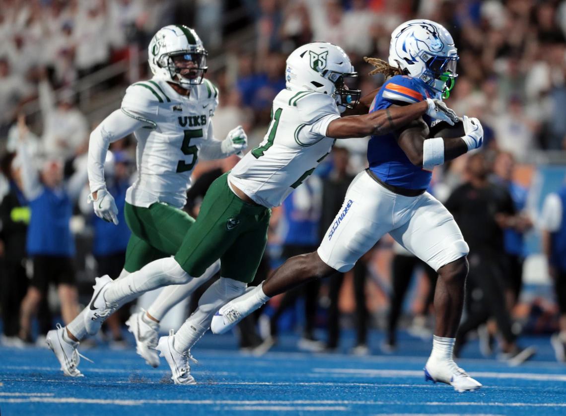 Boise State running back Ashton Jeanty carries Portland State cornerback Jamal McMurrin on a 68 yard run during the first half of the game at Alberston Stadium. Boise State leads Portland State 28-7 at the half at Albertsons Stadium in Boise, Idaho.