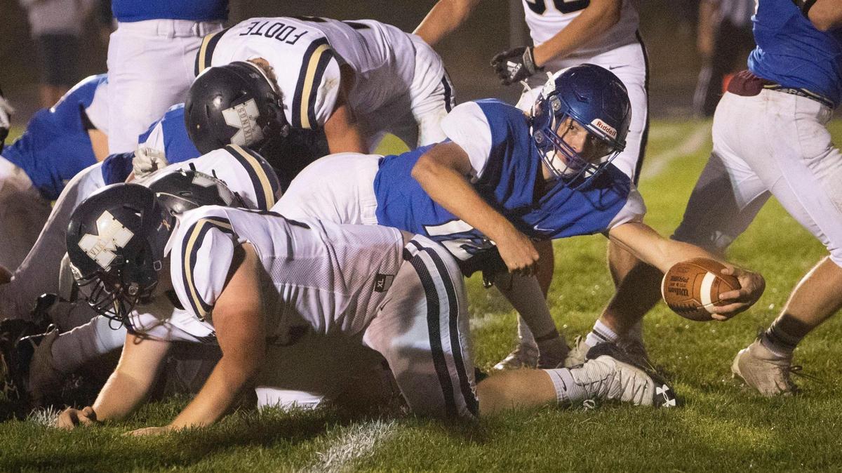 Emmett quarterback Caden Young reaches over the goal line for Emmett’s second touchdown Friday against Middleton.