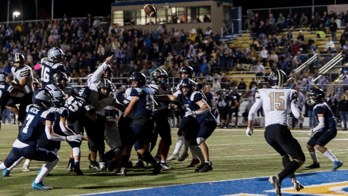 Kuna’s Gus Austin lobs a pass over Middleton’s defense to a wide-open Colton Deatherage on the game-winning two-point conversion play Friday at Middleton High. Kuna defeated its 5A SIC rival 22-21.