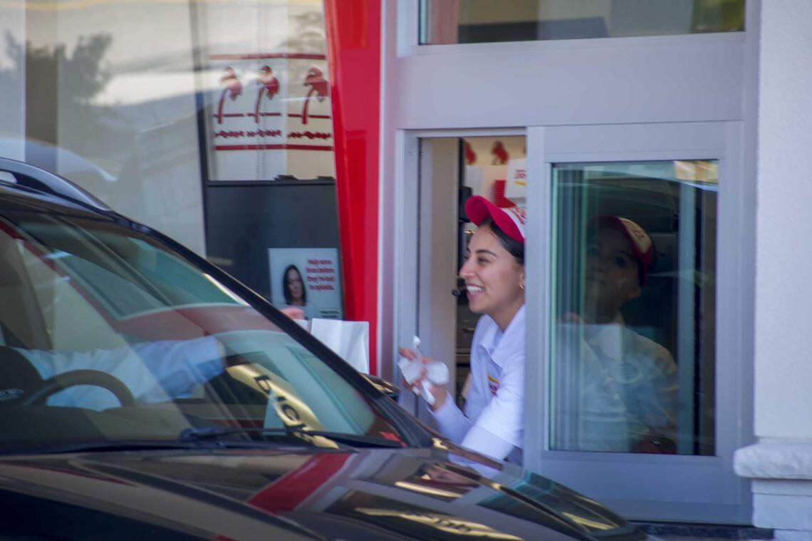 In-N-Out associates greet customers and hand them their food. The associates went through extensive training for their first day at the California-based chain’s new location in Boise, Friday, Nov. 25, 2024.