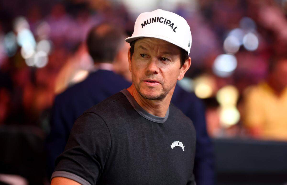 Actor Mark Wahlberg wears a hat from his fitness apparel brand, Municipal, during a UFC event in Las Vegas. 