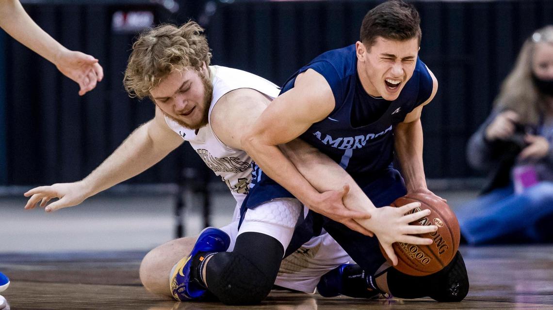 Ambrose guard Johnny Sugarman fights for a loose ball with St. Maries’ Colby Renner in the 2A boys basketball state championship Saturday at the Ford Idaho Center in Nampa.