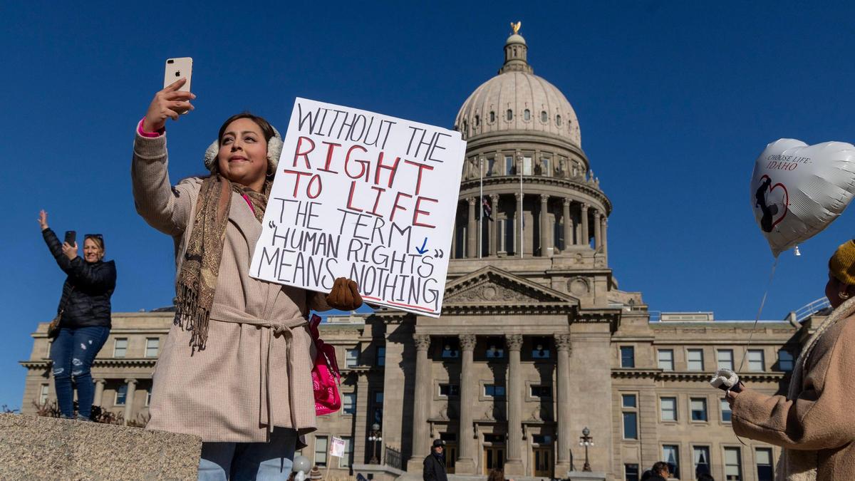 Ariana Jimenez, Boise, holds a Right To Life sign while recording the hundreds of people as they arrive to the Idaho State Capitol Building during the March For Life event organized by Right To Life of Idaho, Saturday, Jan. 25, 2025.