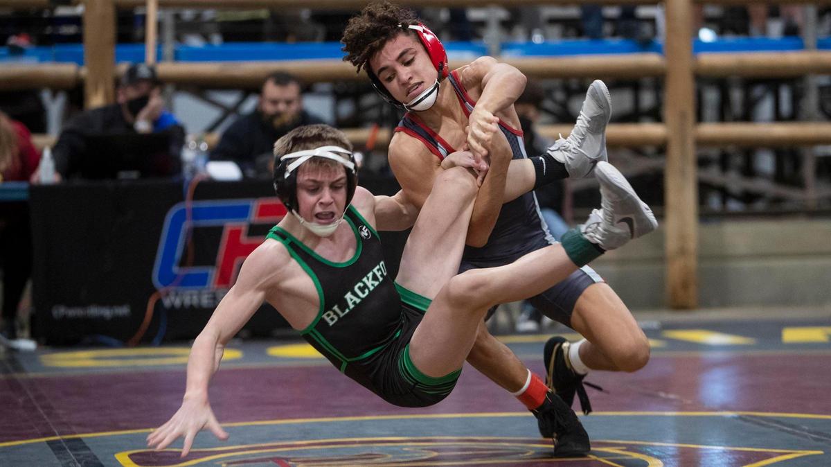 Nampa’s Dedrick Navarro puts a move on Blackfoot’s Mack Mauger in the finals of 98-pound division Saturday at the Rollie Lane Wrestling Invitational. Navarro won 3-2 to repeat as a Rollie Lane champion.