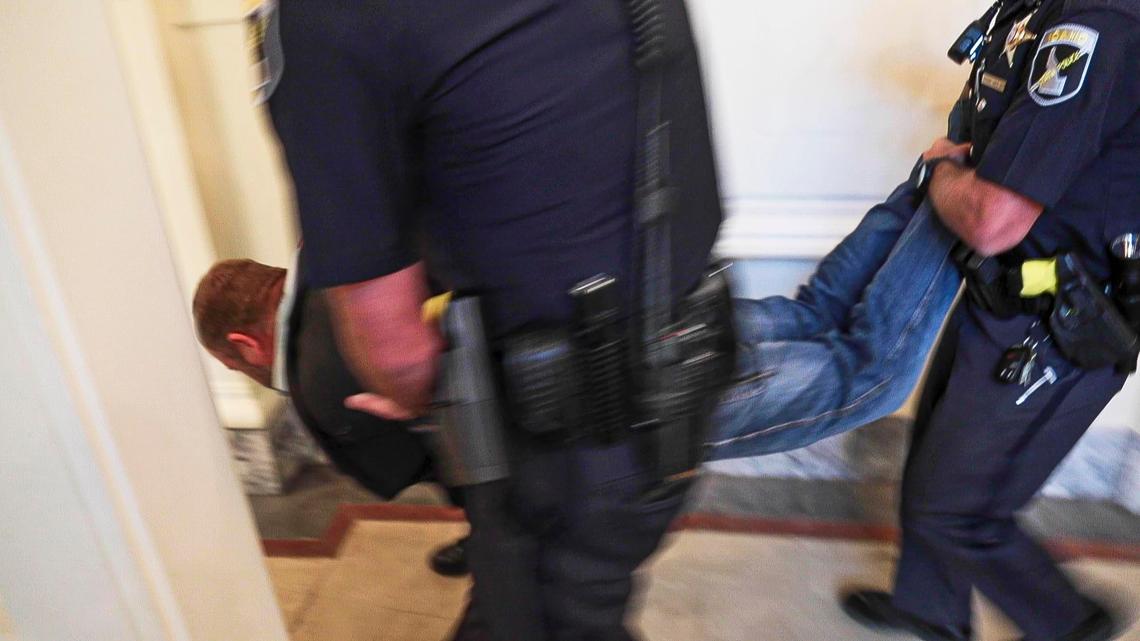 Ammon Bundy is dragged and then carried from the Idaho Senate Chambers gallery by Idaho State Police after returning to the Idaho Statehouse Wednesday, Aug. 26, 2020 in Boise. Officers cited a no-trespass statute before taking Bundy into custody a day after being arrested for refusing to leave a committee meeting.