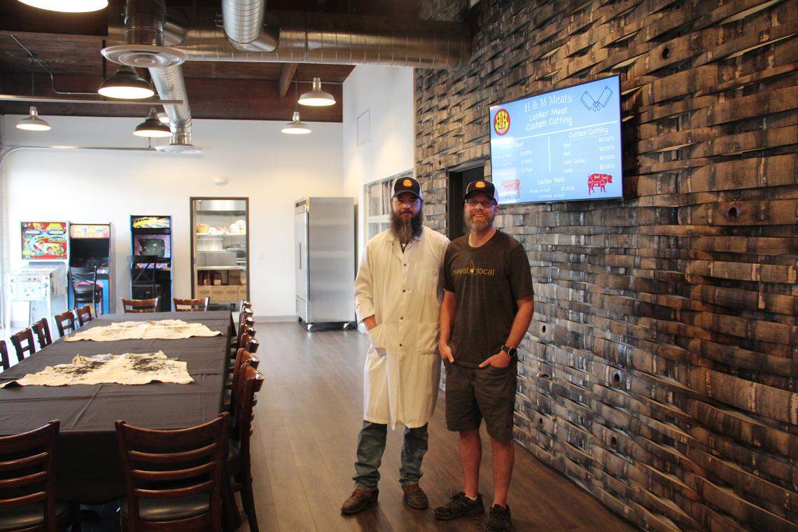 Chef Allen Barrett and owner Adam Hutchings of H&M Meats stand in their newly renovated space at 215 14th Ave. S. in downtown Nampa. Behind them, the wall is decorated with strips of old whiskey barrels from Mother Earth Brewing.