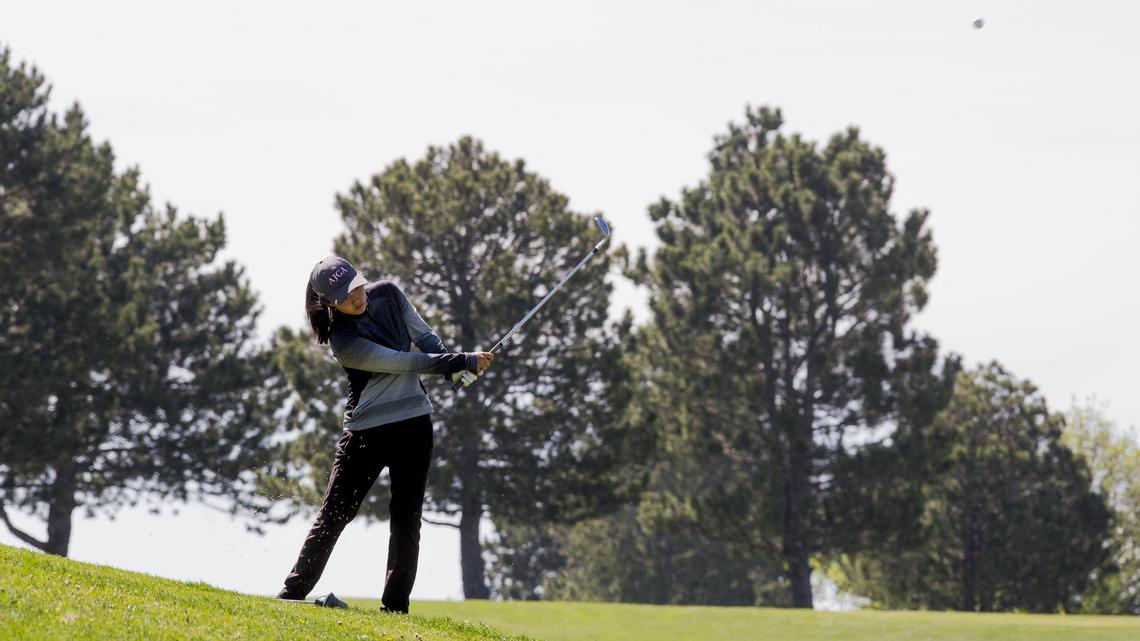 Eagle High freshman Christine Cho chips onto the 8th green during the 5A District Three girls golf tournament Tuesday at Centennial Golf Course in Nampa. Cho and the Mustangs won the team title by one stroke over Boise.