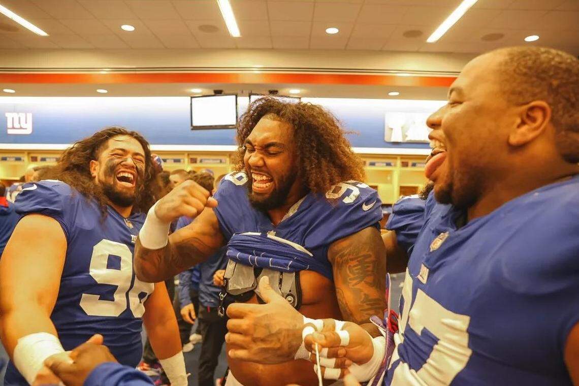 Defensive tackle David Moa, left, and fellow defensive linemen Leonard Williams, center, Dexter Lawrence joke around in the locker room Sunday. The Giants defeated Carolina 25-3.