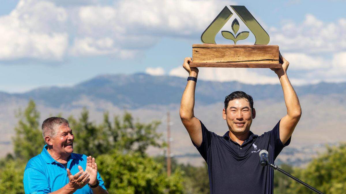 Golfer Chan Kim receives his trophy Sunday after winning the Albertsons Boise Open at Hillcrest Country Club.