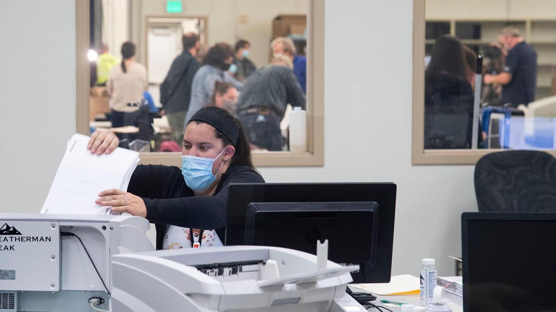 A worker at the Ada County Election Headquarters in Boise processes absentee ballots in this 2020 file photo.