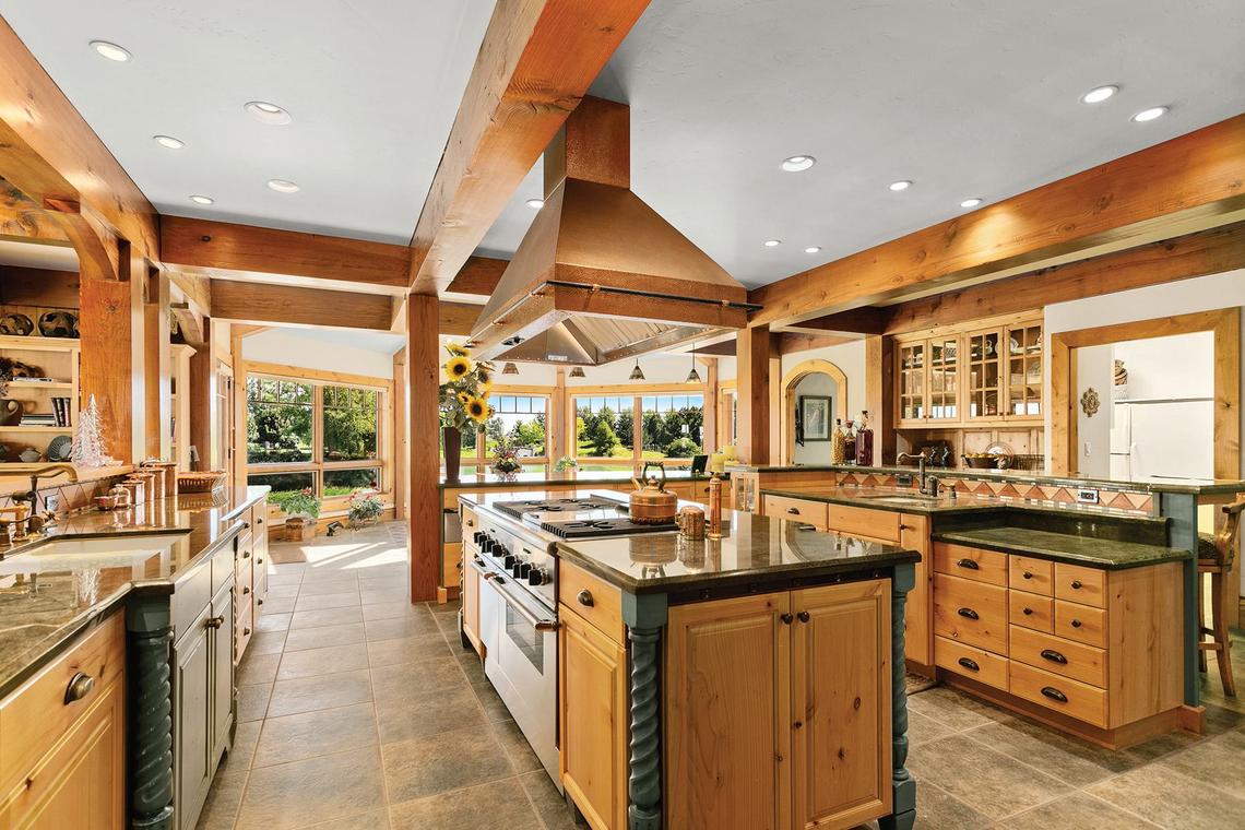 The wood-filled kitchen of the Williamses’ Tree Top Ranches looks out onto their property.