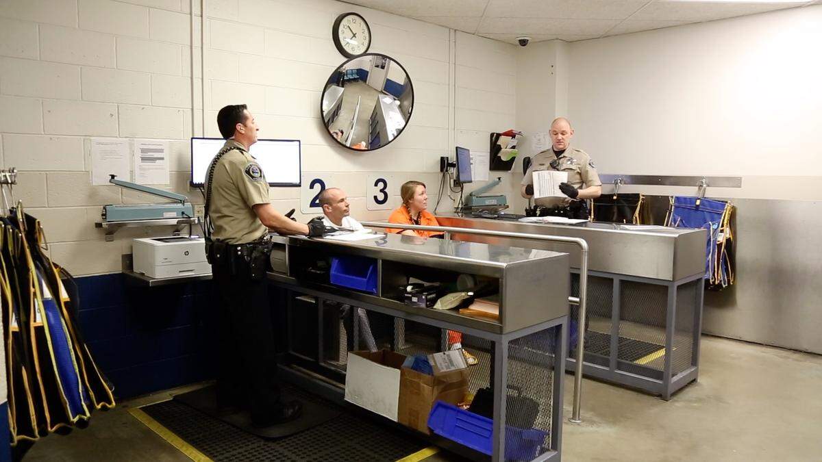 Sheriff's deputies process newly arrested inmates in the intake area of the Ada County jail.  Sheriff Stephen Bartlett is asking county commissioners for money next year to hire eight booking nurses to evaluate and care for inmates.
