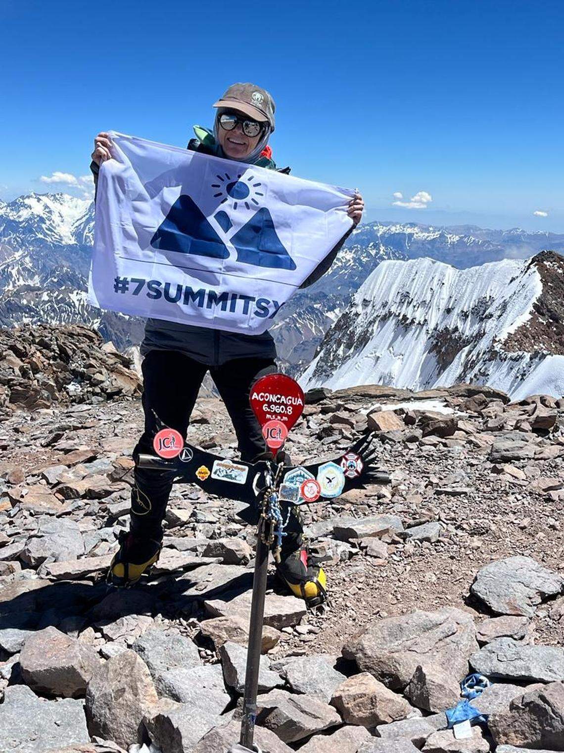 Eva Steinwald, of Meridian, holds a Seven Summits flag at the summit of Aconcagua, the 22,000-foot tallest peak in South America. Steinwald is trying to summit the tallest peak on each of the seven continents.