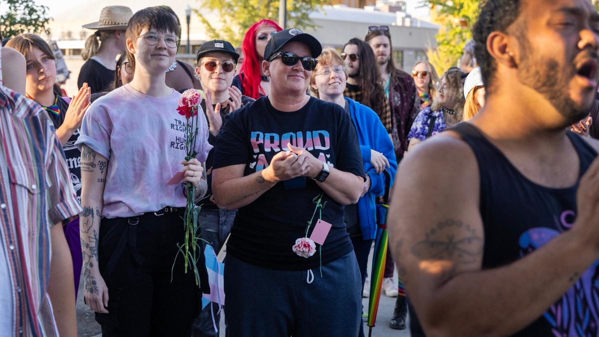 People carry signs and flags in support of transgender people during the Trans March in Boise, Friday, Sept. 13, 2024.
