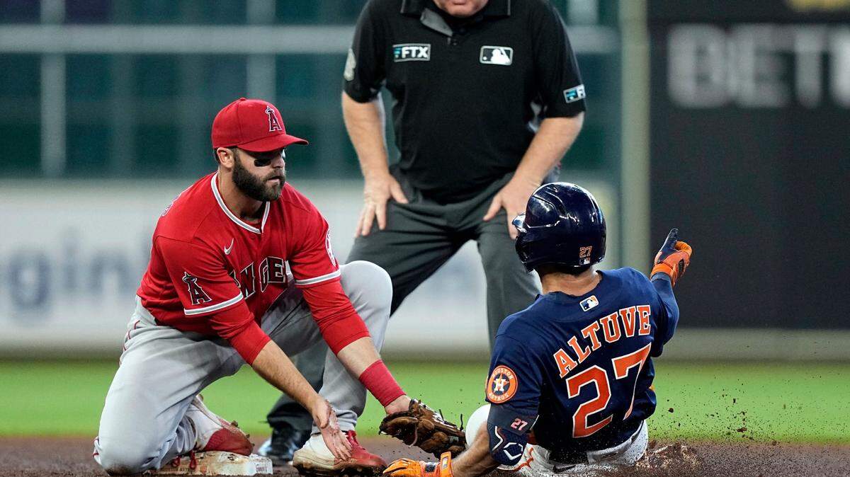 Houston Astros’ Jose Altuve (27) is tagged out by Los Angeles Angels second baseman Michael Stefanic while trying to stretch a single into a double during the fourth inning of the Astros’ 4-2 win on Sunday in Houston. (AP Photo/David J. Phillip)
