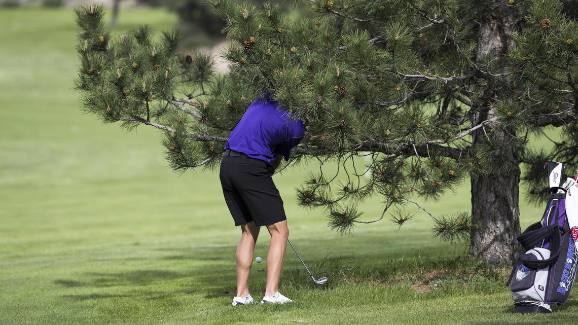 Rocky Mountain's Carson Barry hits out of a sticky situation on the 5th hole fairway during the 5A District Three boys golf tournament Wednesday, May 9, 2018 at Centennial Golf Course in Nampa.