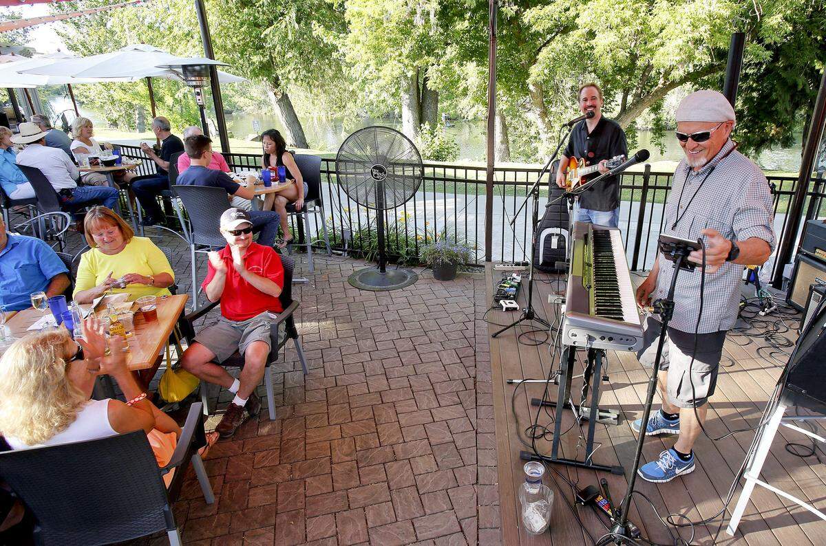 Steve Eaton and Jon Klein (back, guitar) entertain patrons on the patio of Sandbar Patio Bar & Grill.