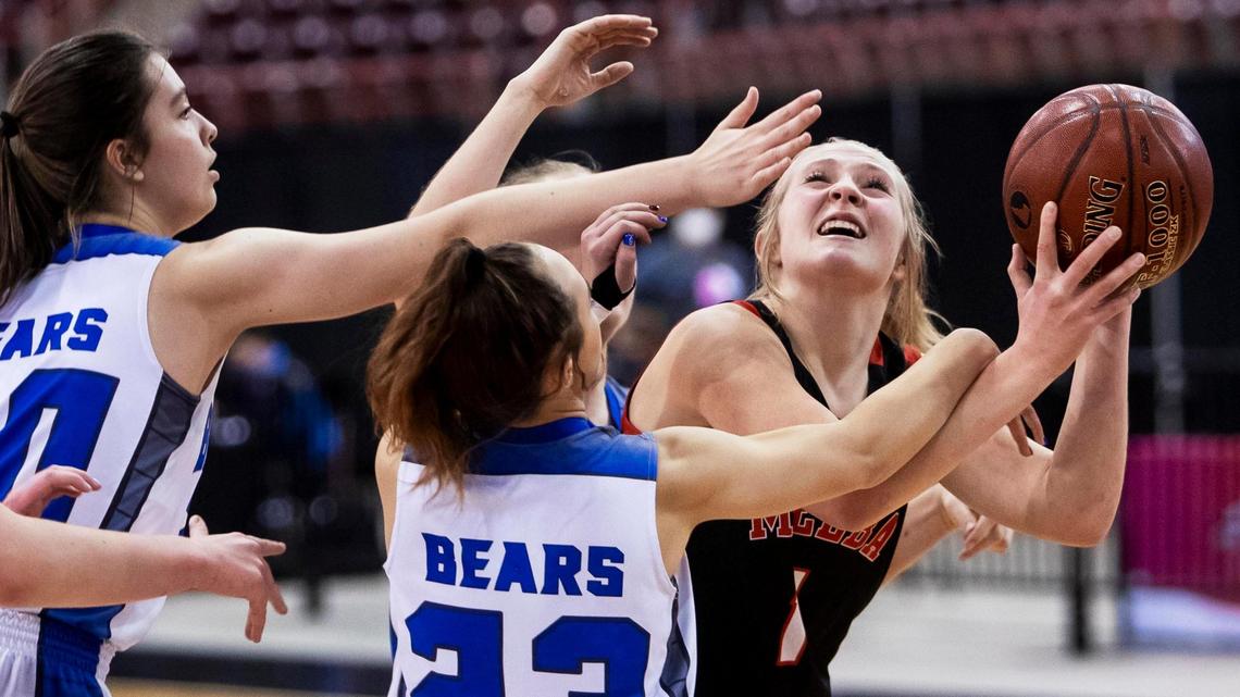 Melba forward Keylee Wilson is fouled by Bear Lake’s Oakley Crane on Saturday at the Ford Idaho Center.