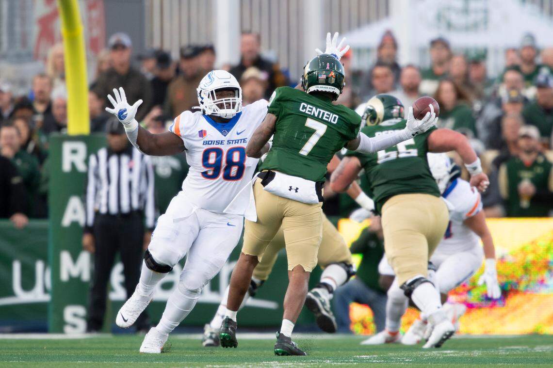 Boise State defensive tackle Herbert Gums pressures former Colorado State quarterback Todd Centeio during a game last season. Gums was a 250-pound running back at Diboll High School in Texas.
