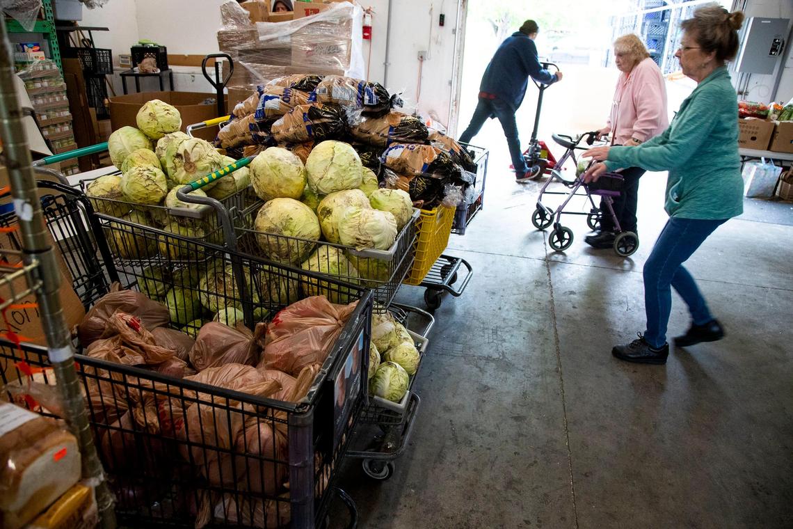 Volunteers at the Vineyard Boise Christian Fellowship food pantry fill boxes with donated fruits and vegetables, meats, milk and cheese and boxed items meant to provide needy families with more than a week’s worth of food.