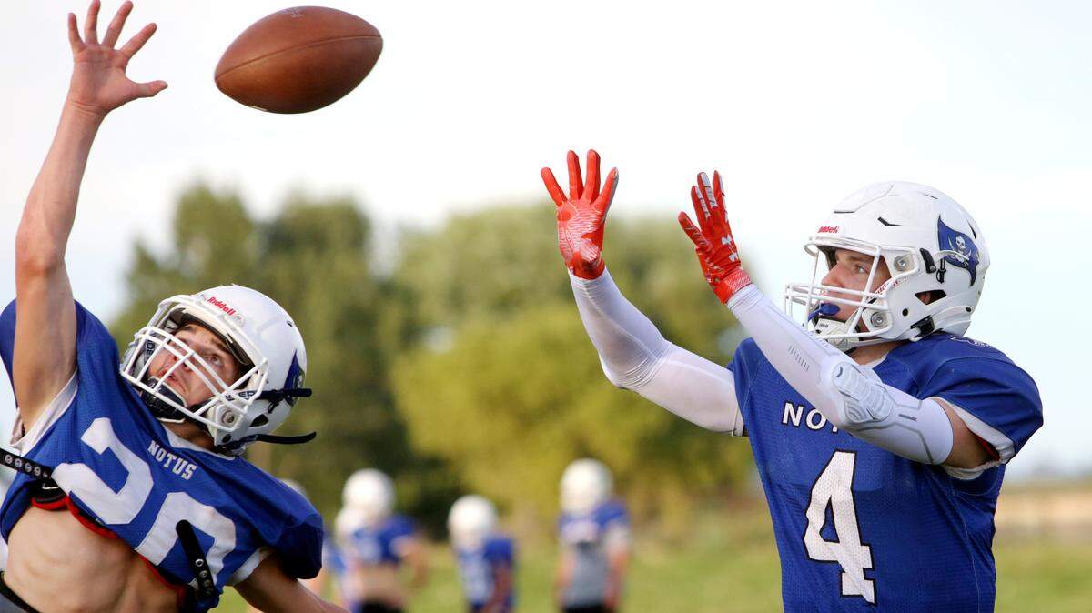 Notus running back Carter Woodland, right, hauls in a pass during a preseason practice Thursday at Notus High. Woodland returns as the reigning 1A Division I WIC Offensive Player of the Year.