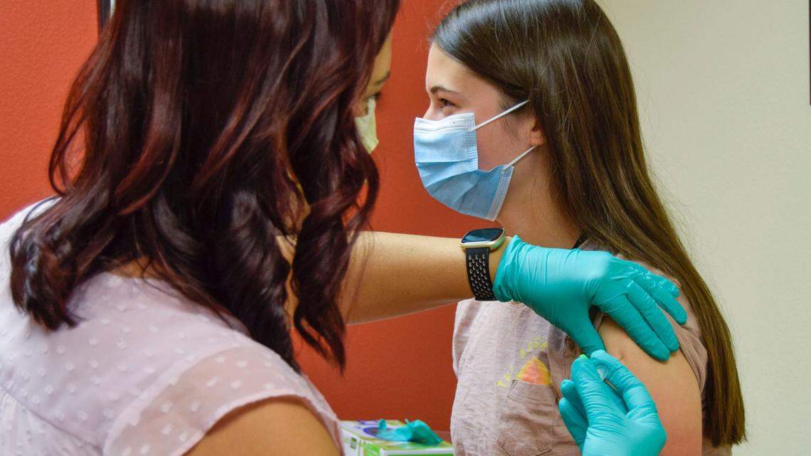 A teenager receives the COVID-19 vaccine in May 2021.