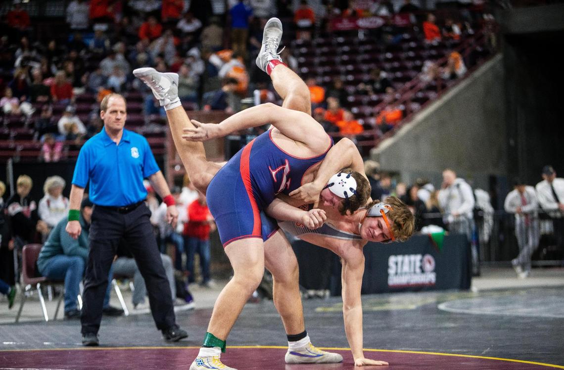 New Plymouth’s Hunter Williams, left, and Pries River’s Matyus McLain battle in the 2A 220-pound state championship Saturday at the Ford Idaho Center.