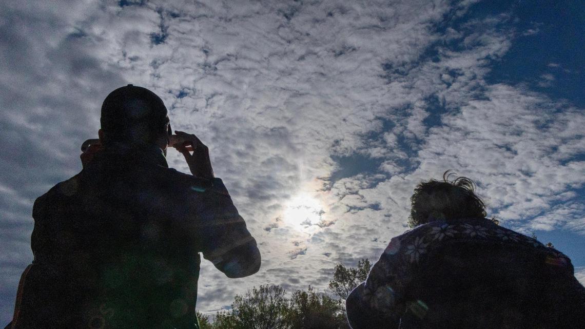 People view the annular solar eclipse through special glasses at Boise State University, Saturday, Oct. 14, 2023. Boise State Physics’ Central Idaho Dark Sky Reserve STEM Network hosted an eclipse watch event at the Student Union Intramural Field.