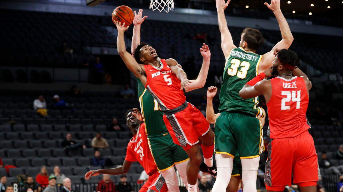 New Mexico guard Jamal Mashburn Jr. takes a shot between San Francisco forward Zane Meeks and center Volodymyr Markovetskyy during the first half of their game Dec. 12 in Las Vegas.