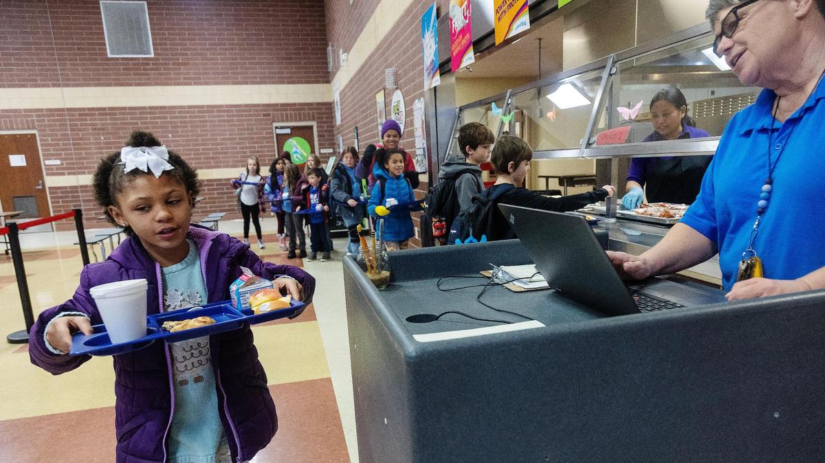Siena Elementary School student Nevaeh Bunton checks out her meal with kitchen manager Julie Byers. Next school year, the Boise School District will offer free breakfast to all students.