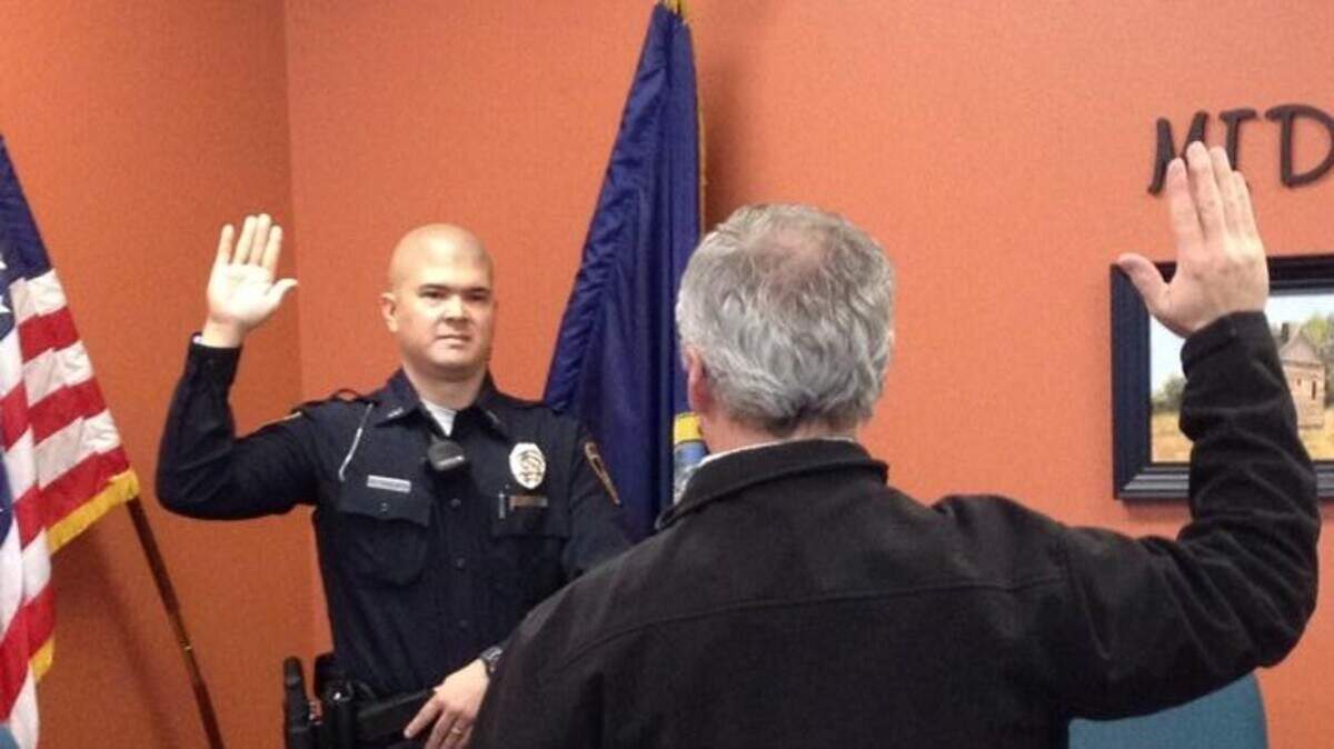 Former Middleton Mayor Darin Taylor swears in officer Alan Takeuchi to the Middleton Police Department in 2015. Takeuchi became police chief two years later.